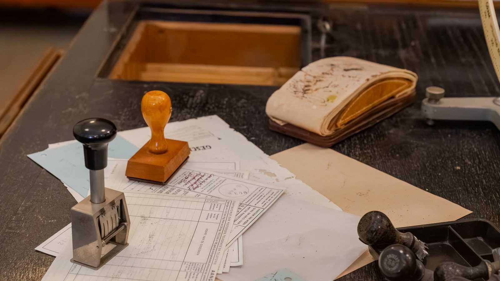 Municipal procurement desk with rubber stamps and bid documents used to check a surety bond against Treasury Circular 570 and the power of attorney before acceptance