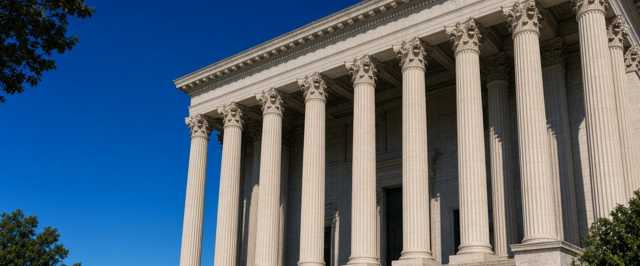 Neoclassical courthouse with Corinthian columns and stone steps under a deep blue sky, representing an appellate court ruling on a prejudgment surety bond